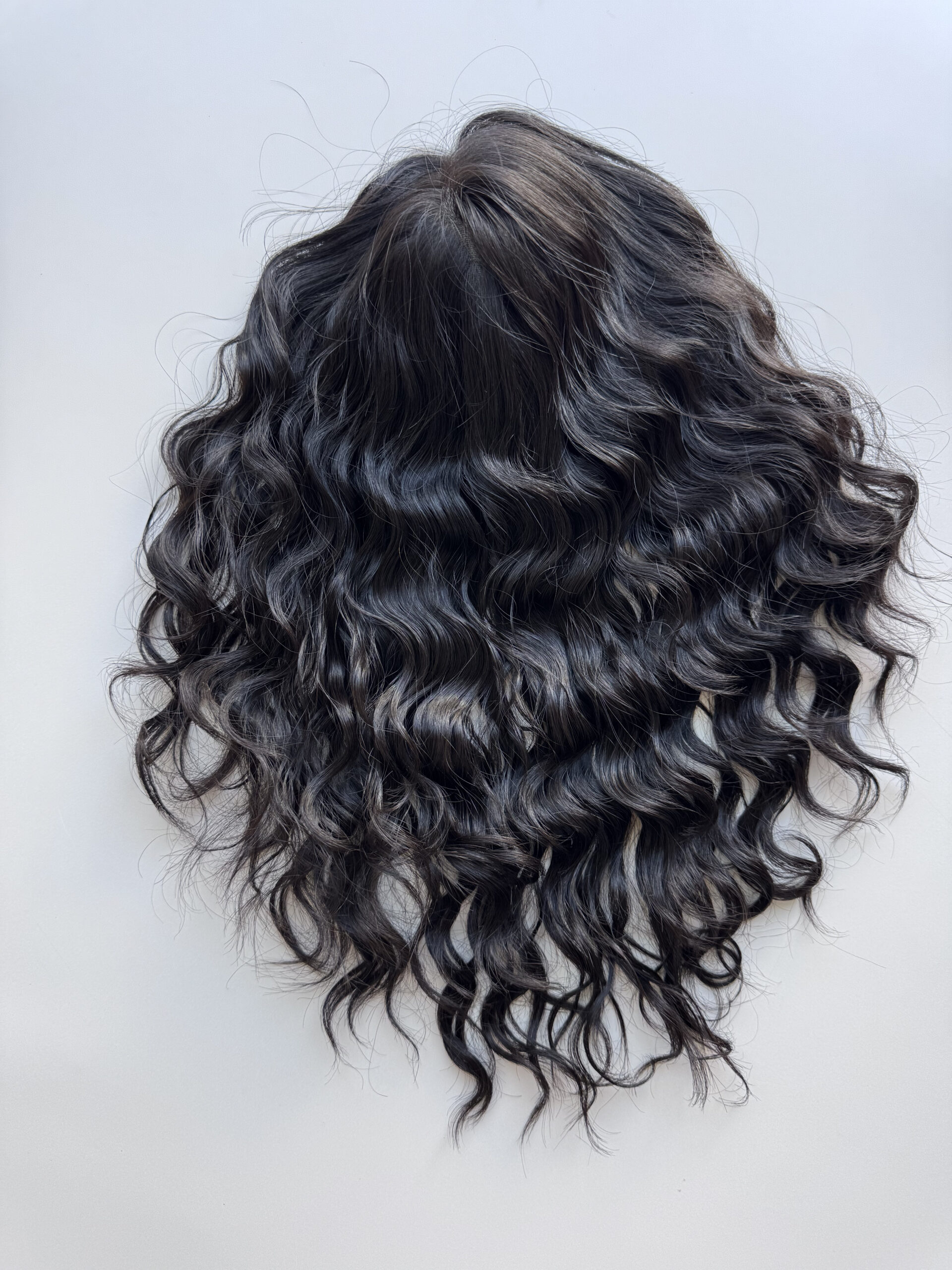 Darkhair curlyhair topper made from natural hair. Ideal for alopecia, fine and thinning hair, or lack of density.